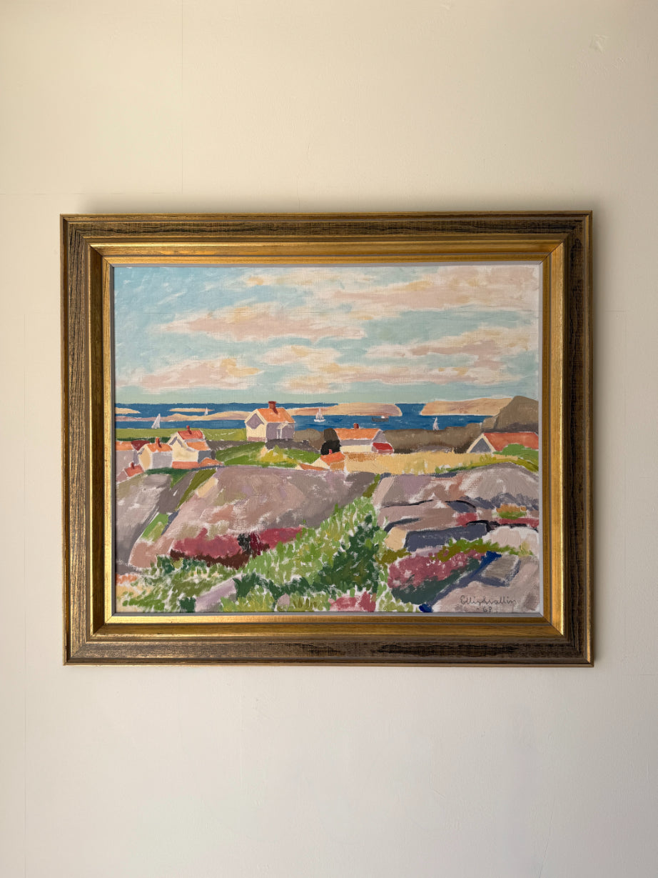 Framed vintage oil painting of a coastal village scene. Available at Hue. 