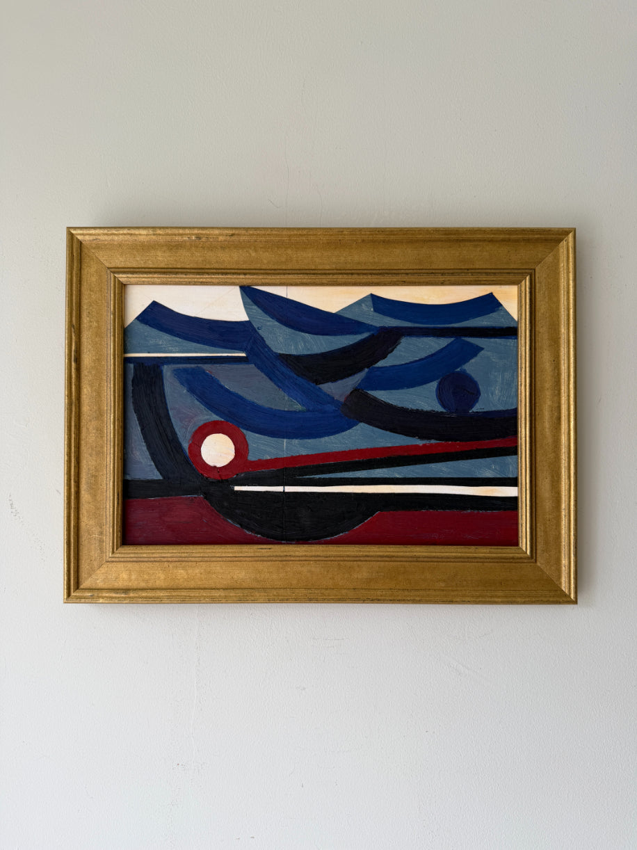 A framed vintage abstract geometric painting featuring blue, navy, black, red, and cream shapes, housed in a gold-toned wooden frame. Available at Hue. 