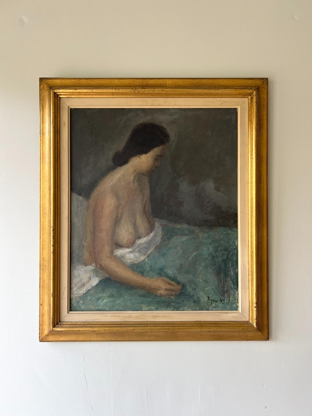 Framed vintage oil painting of a nude woman sitting on a bed with a gold vintage frame, available at Hue.