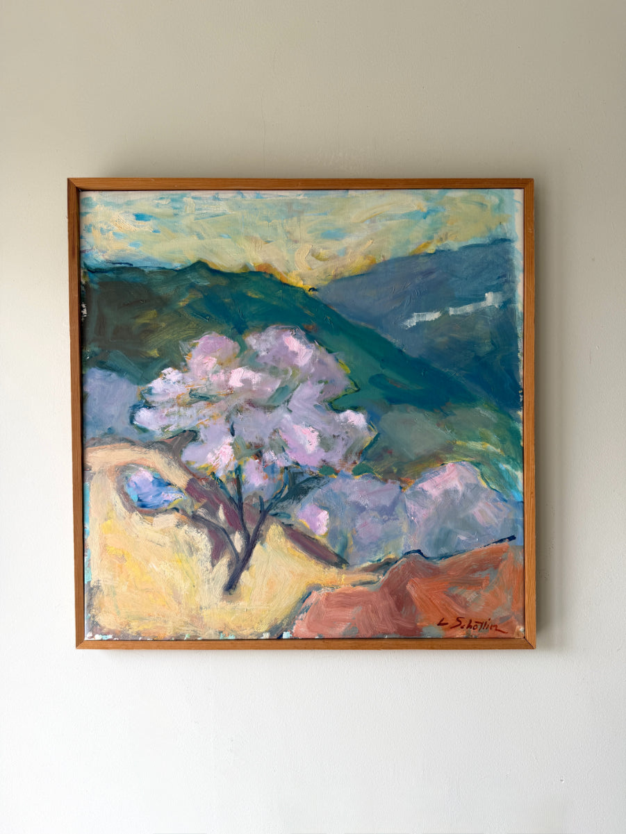 Framed vintage oil painting of a landscape with a blossoming tree and mountains. Available at Hue. 