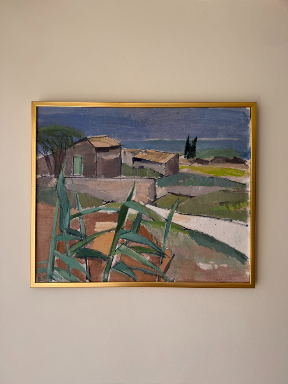 Framed vintage oil painting of a coastal landscape with huts. Available at Hue. 