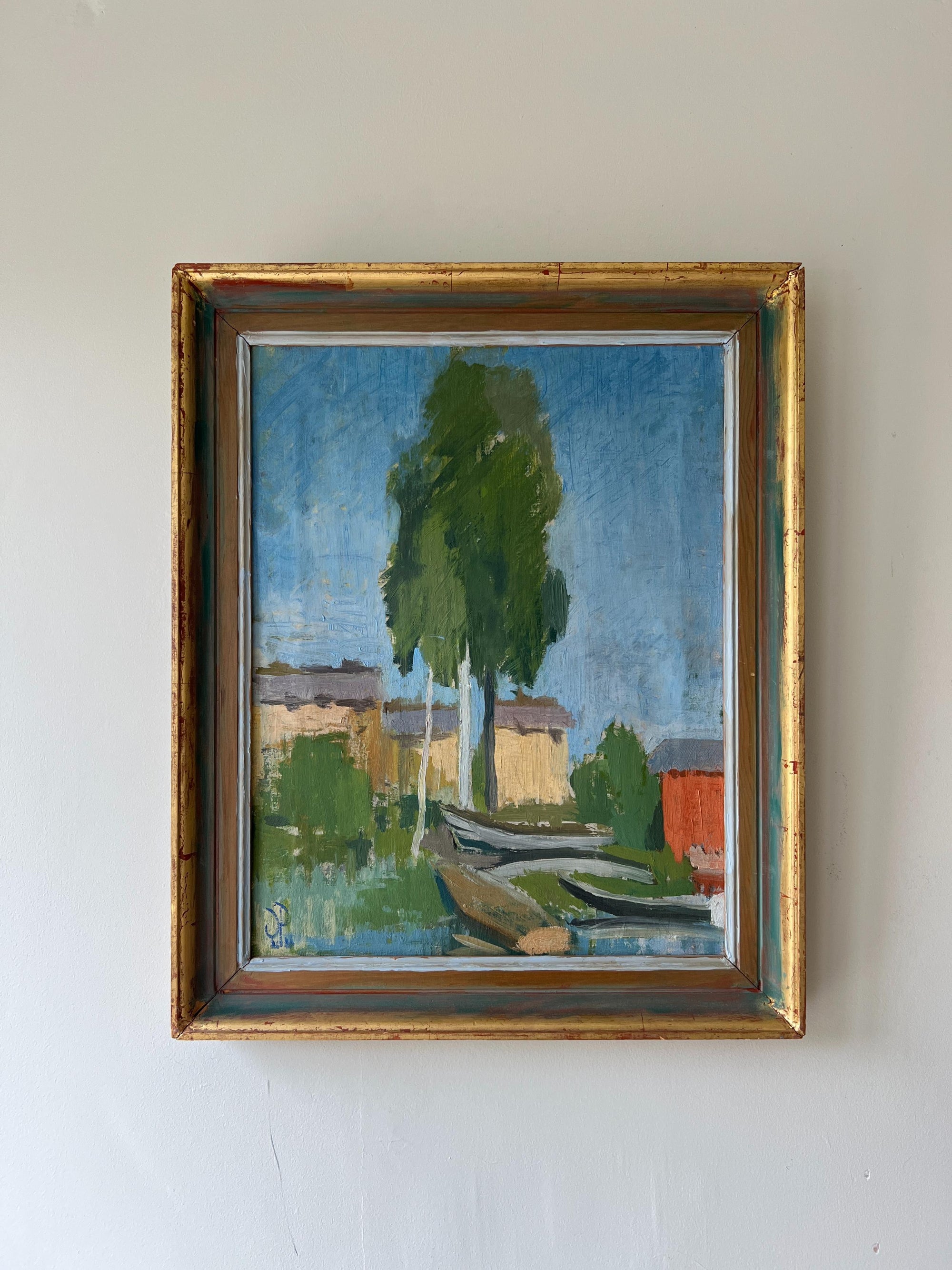 Framed vintage oil painting of wooden boats anchored on the riverside, available at Hue.
