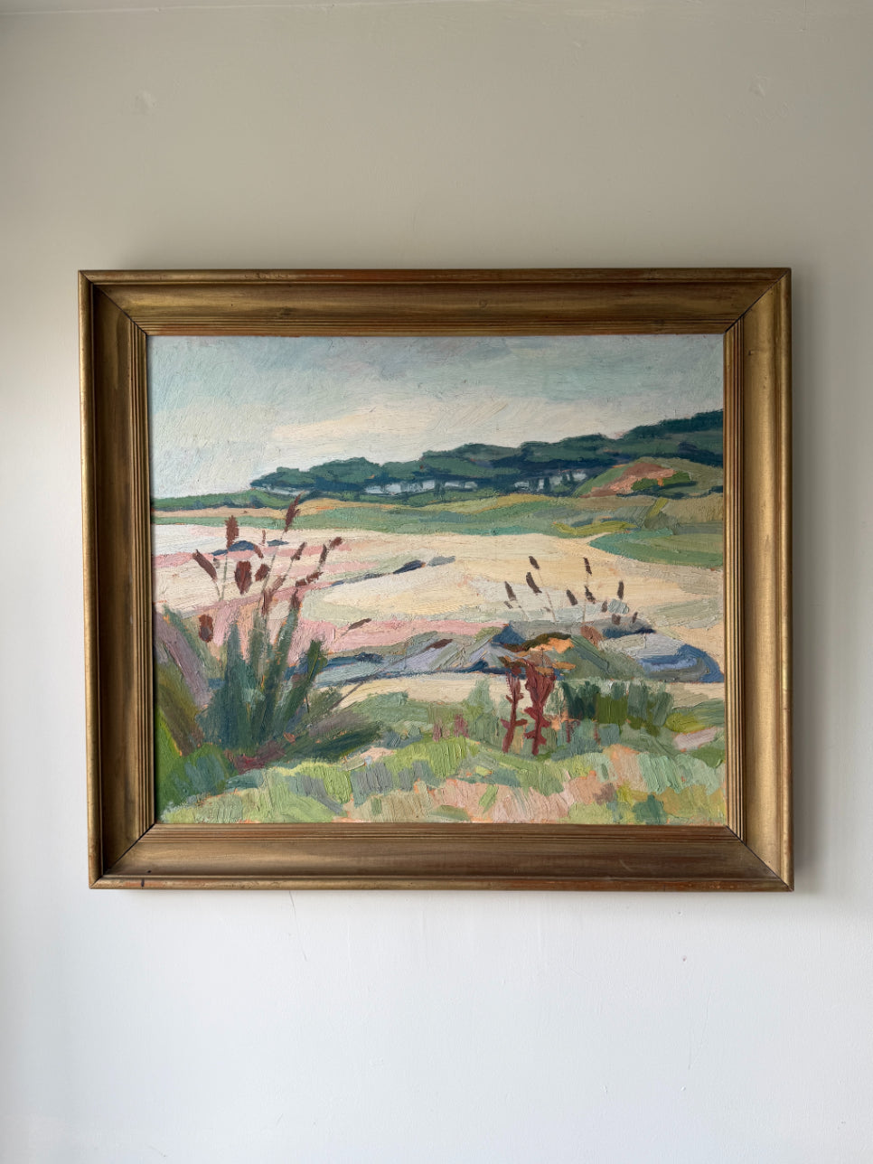 Framed vintage oil painting of a seascape with a beach painted in pastel colours. Available at Hue. 