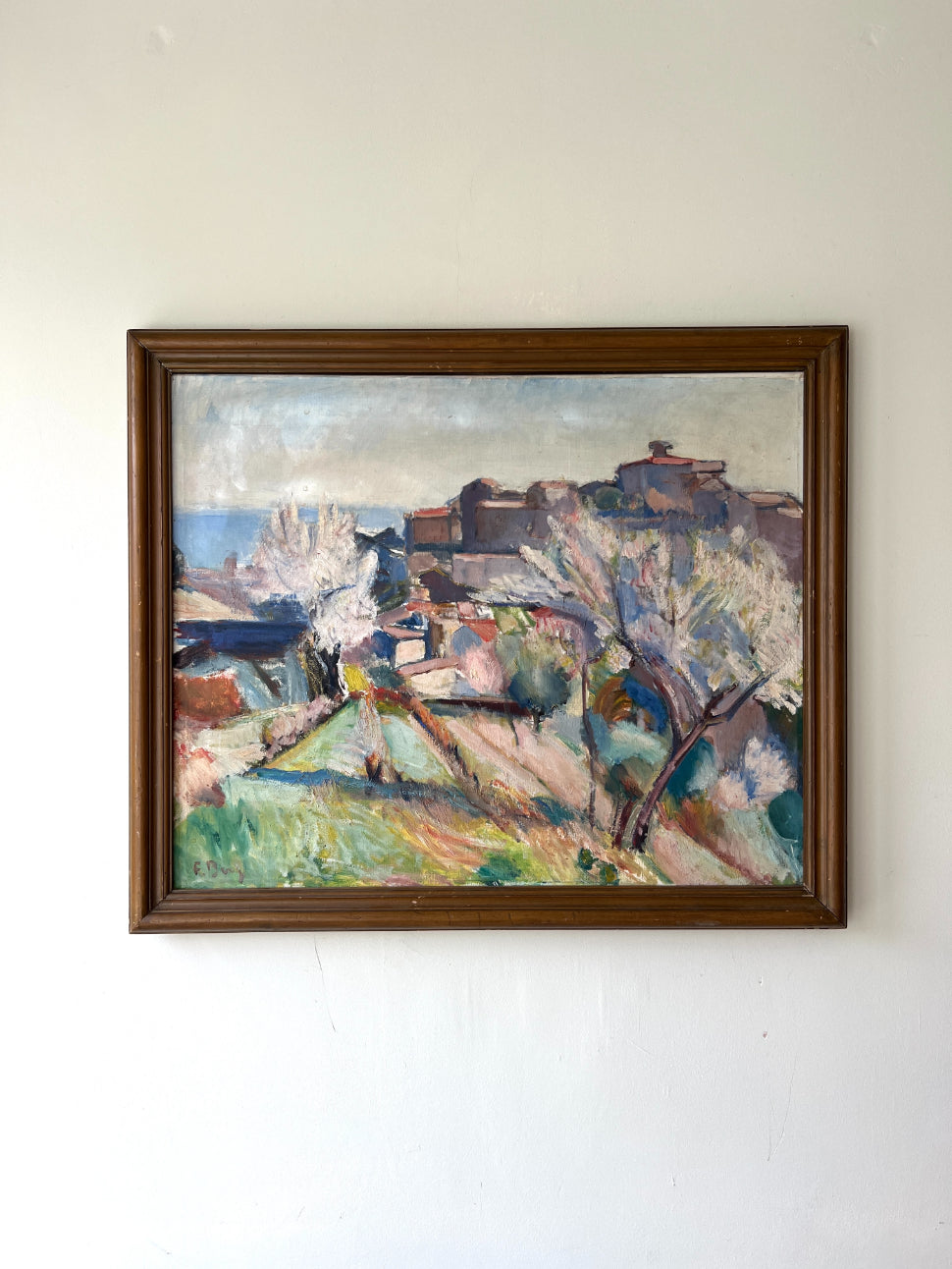 Large framed vintage oil painting of a landscape with blossom and a distant hillside town. Available at Hue. 