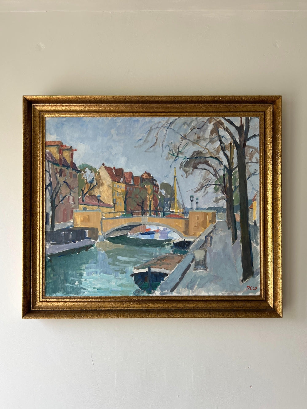 Framed vintage oil painting of a canal scene with trees and buildings in a vintage gilt frame, available at Hue.