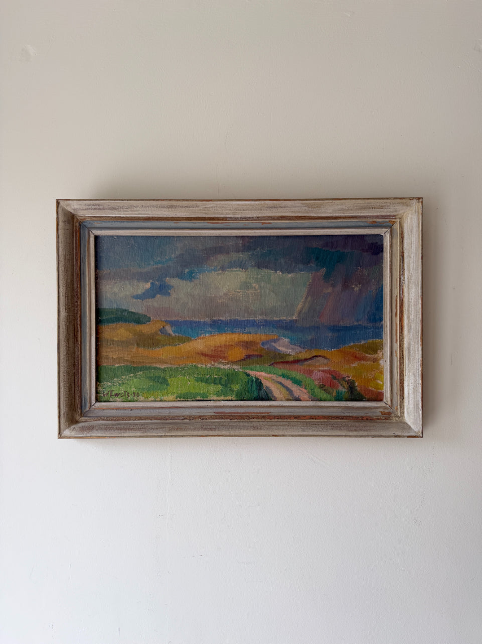Framed vintage oil painting of a seascape with winding coastal track. Available at Hue.
