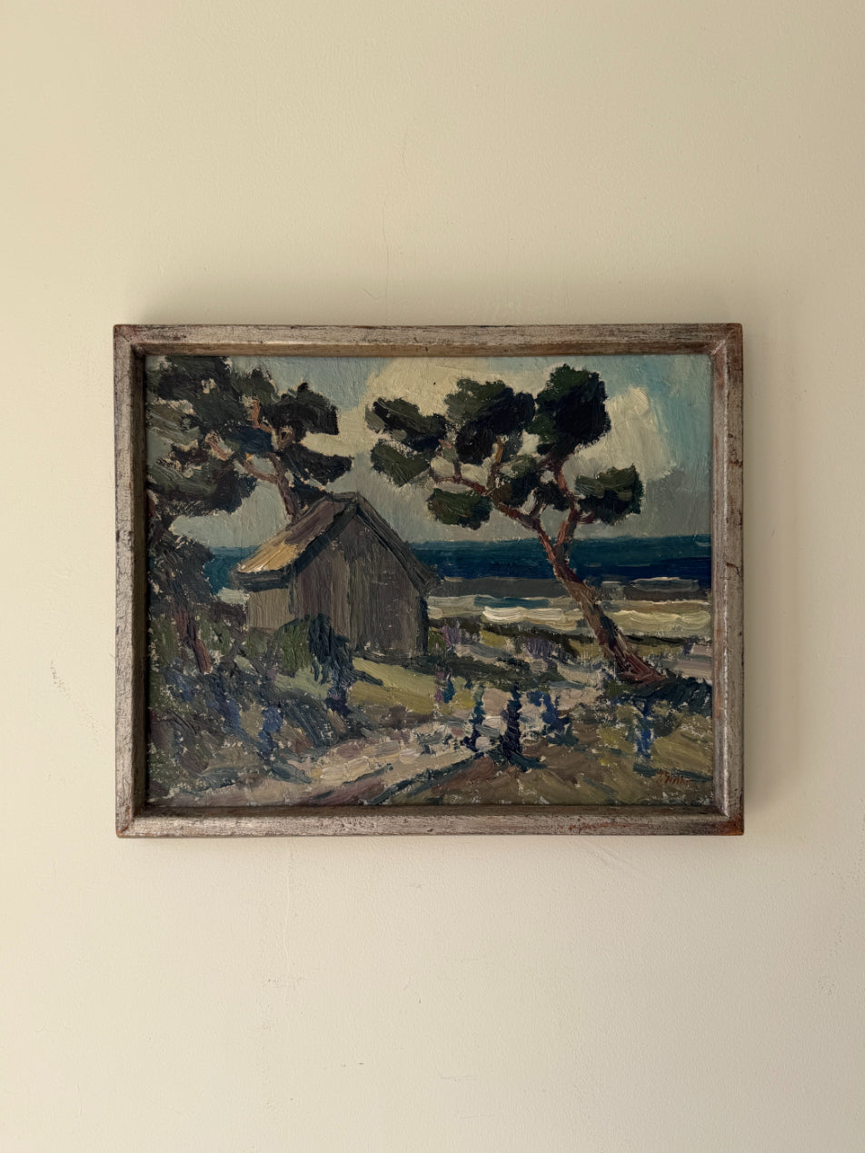 Framed vintage oil painting of a landscape with a house and pine trees by the coast. Available at Hue. 