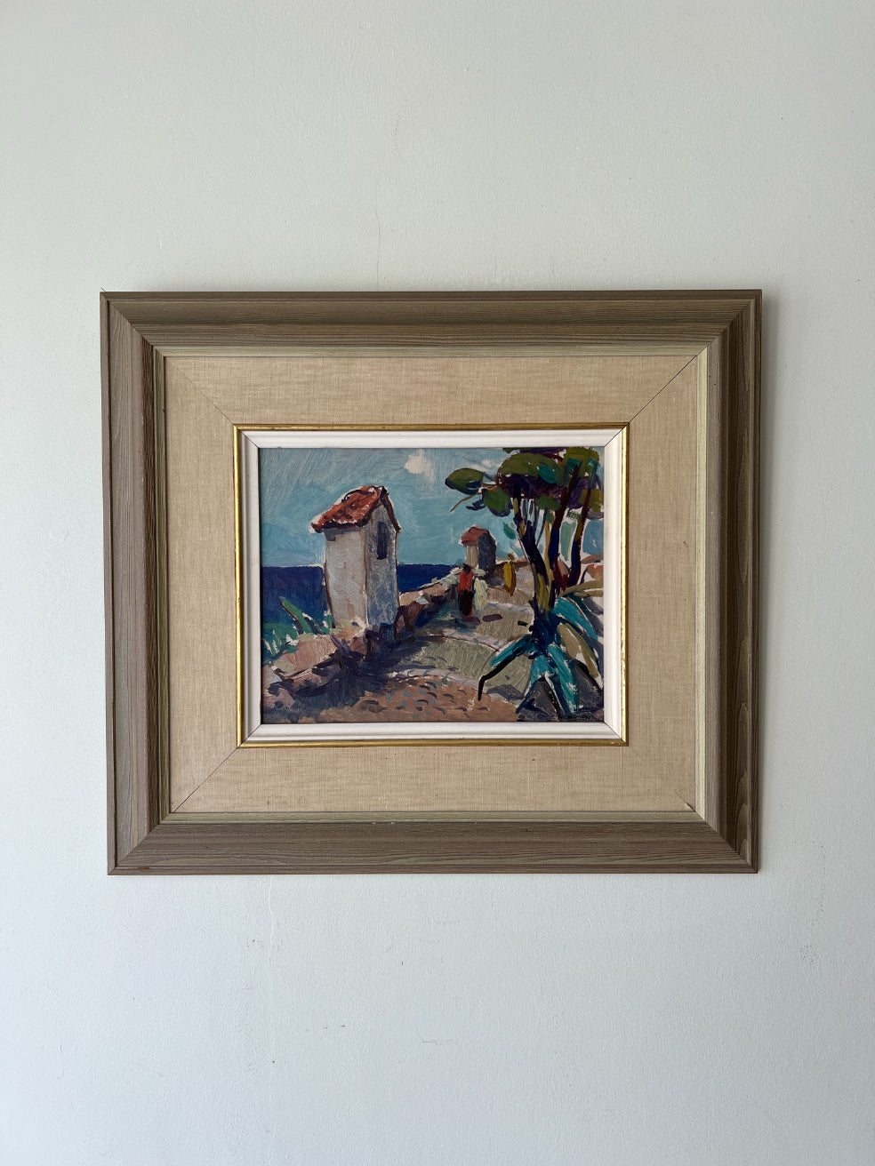 Framed vintage oil painting of a mediterranean coastal scene. Available at Hue.