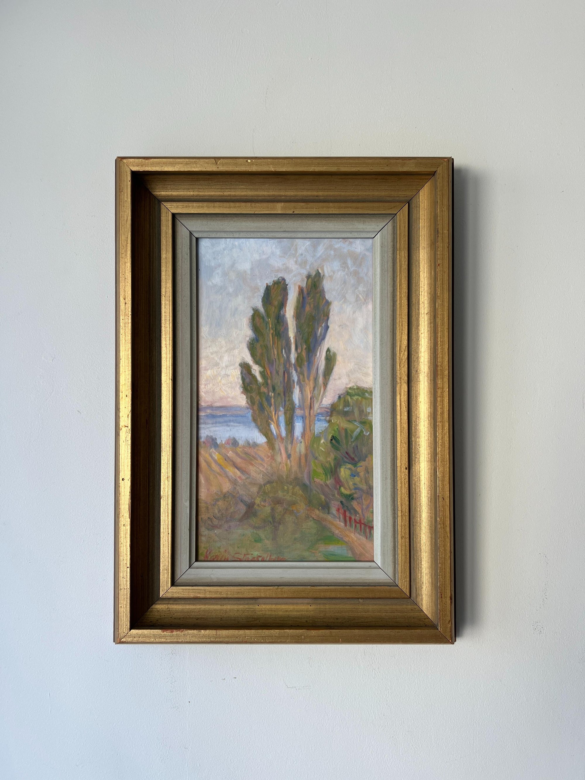 Framed vintage oil painting of a landscape with trees and water. Available at Hue. 