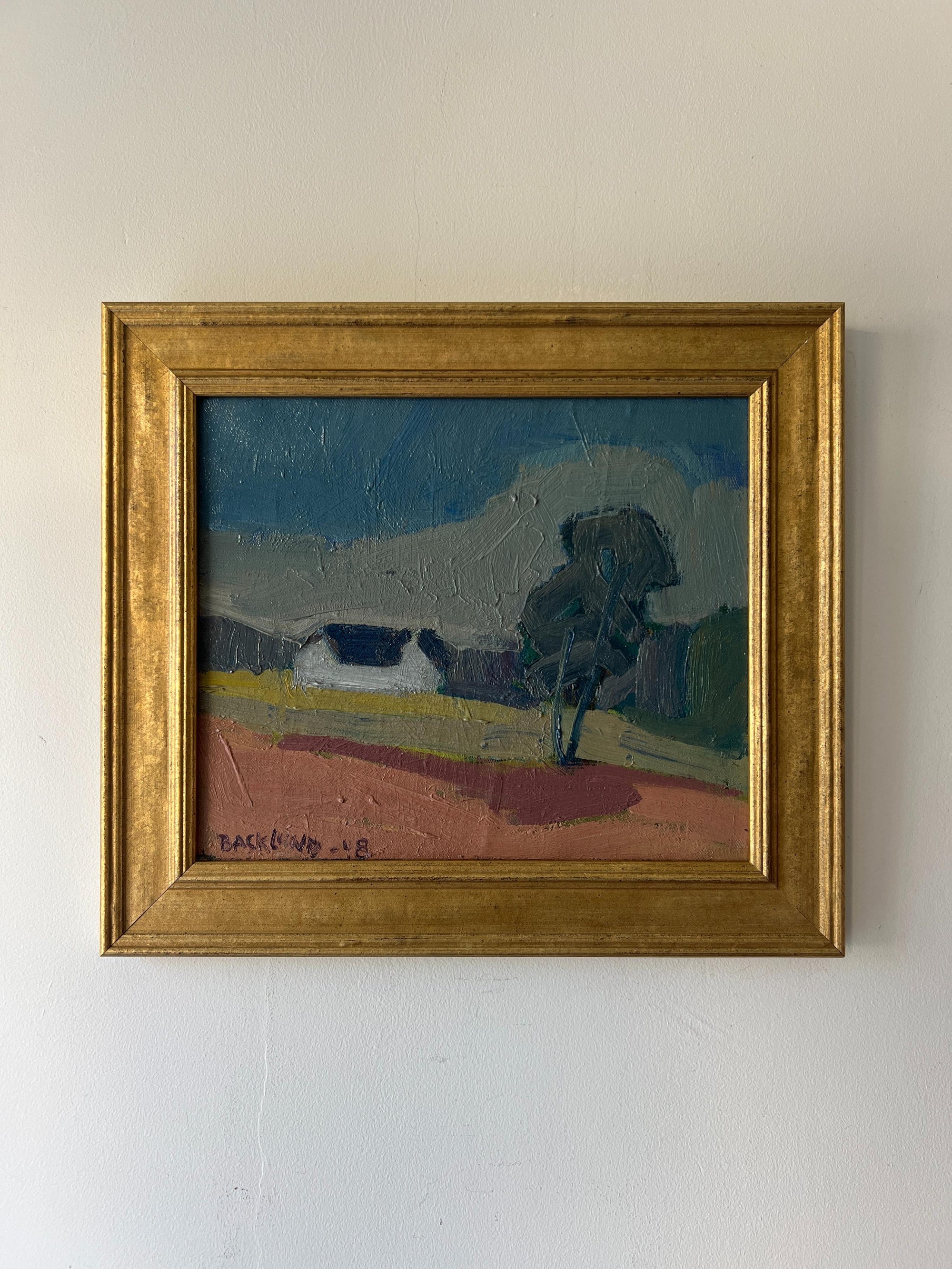 Framed vintage oil painting of a landscape with a white house. Available at Hue. 
