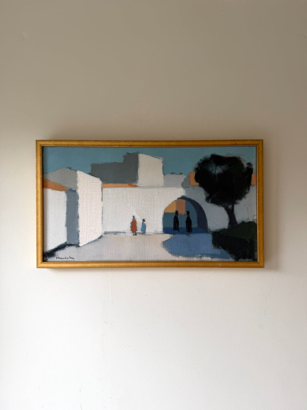 Framed vintage oil painting of a landscape with whitewashed buildings and people. Available at Hue. 