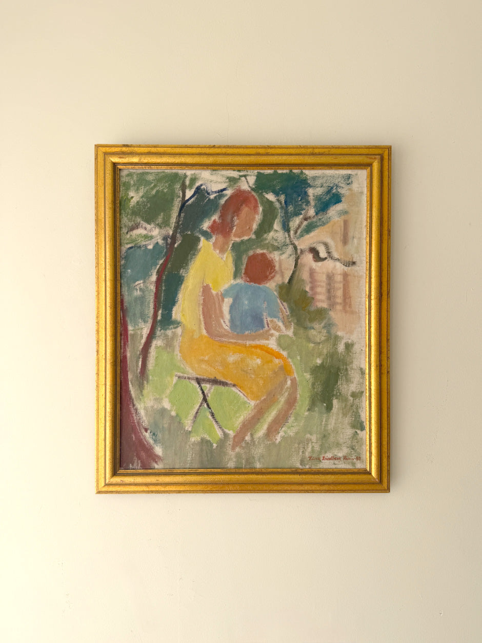 Framed vintage oil painting of a woman holding a child among trees. Available at Hue.