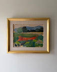 A framed vintage landscape oil painting featuring green fields, rusty red wild flowers, and blue hills. Available at Hue. 