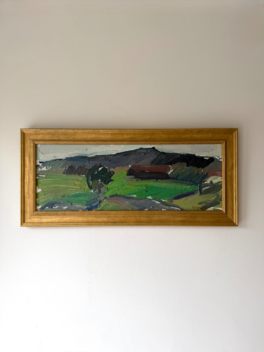 Framed vintage landscape oil painting of a landscape with fields and mountains. Available at Hue