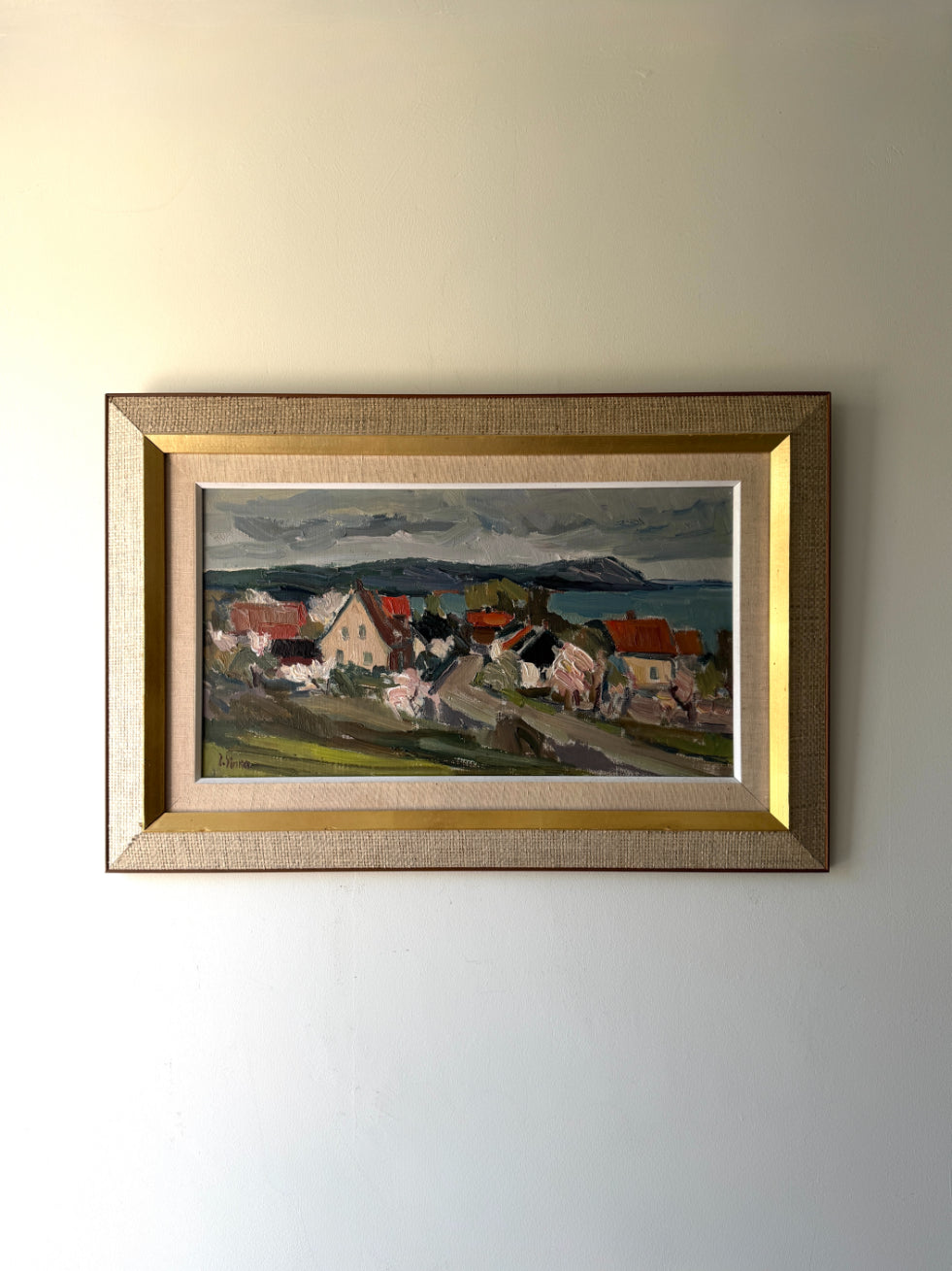 Framed vintage oil painting of a coastal village scene with blossom trees. Available at Hue. 