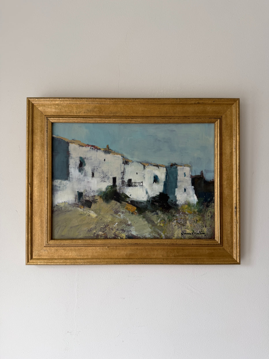 Framed vintage oil painting of whitewashed houses in a village in Ibiza. Available at Hue. 