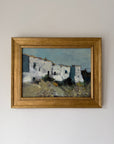 Framed vintage oil painting of whitewashed houses in a village in Ibiza. Available at Hue. 