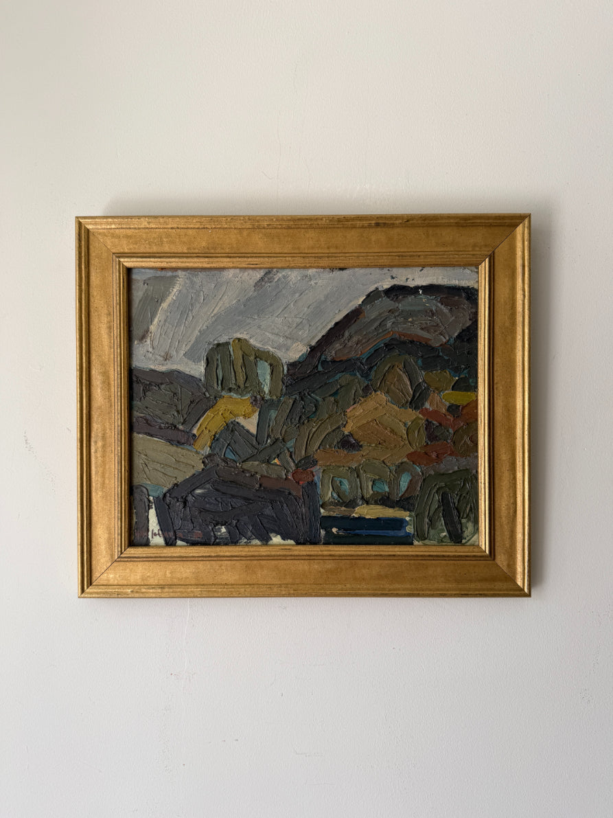 A framed vinatge landscape oil painting with an abstract, impressionistic style, featuring dark mountains and green hills under a cloudy sky. Available at Hue. 
