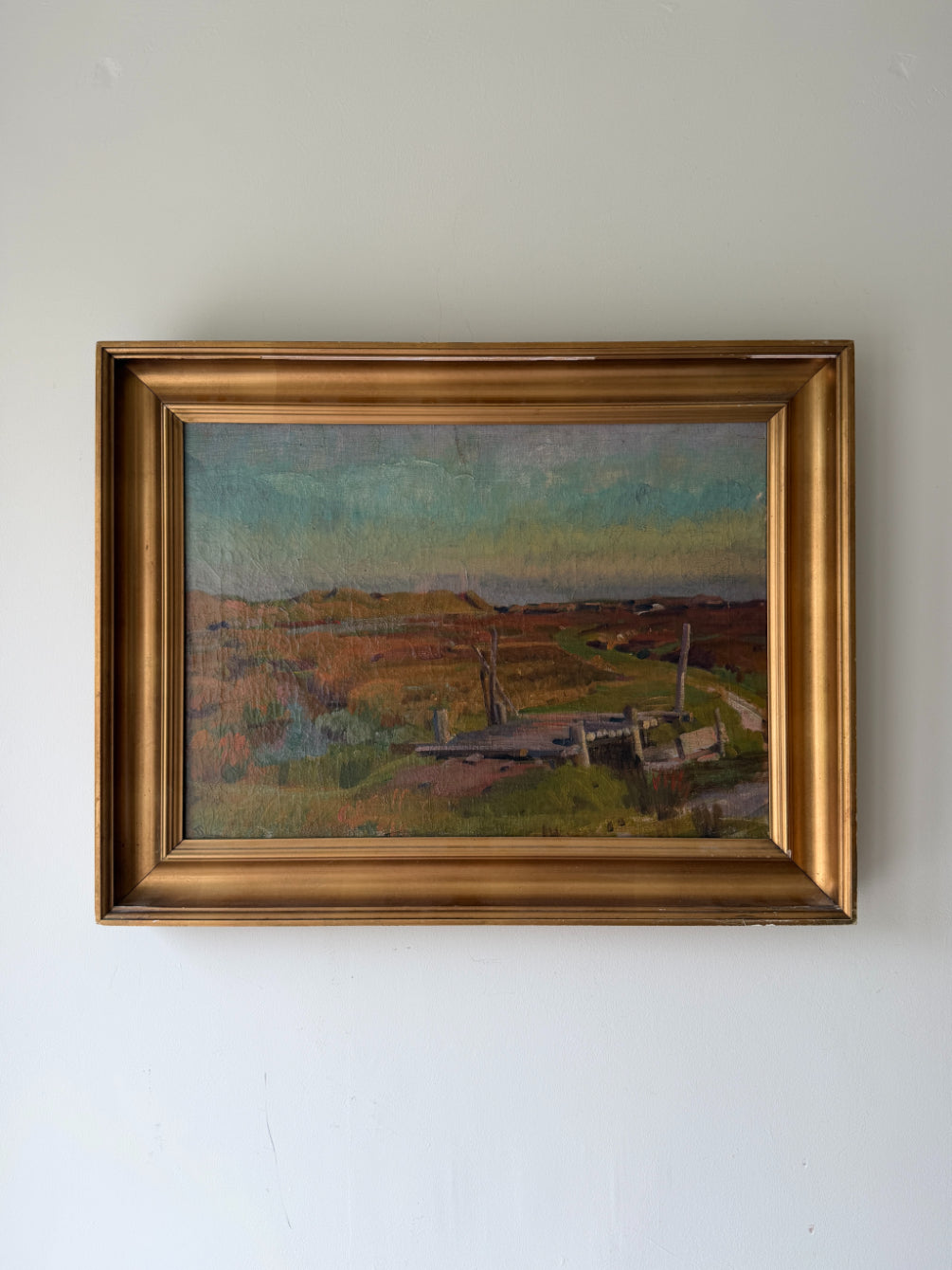 Framed vintage oil painting of a landscape with wooden foot bridge. Available at Hue. 