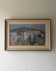 A framed vintage landscape oil painting of a village with mountains in the background. Available at Hue.