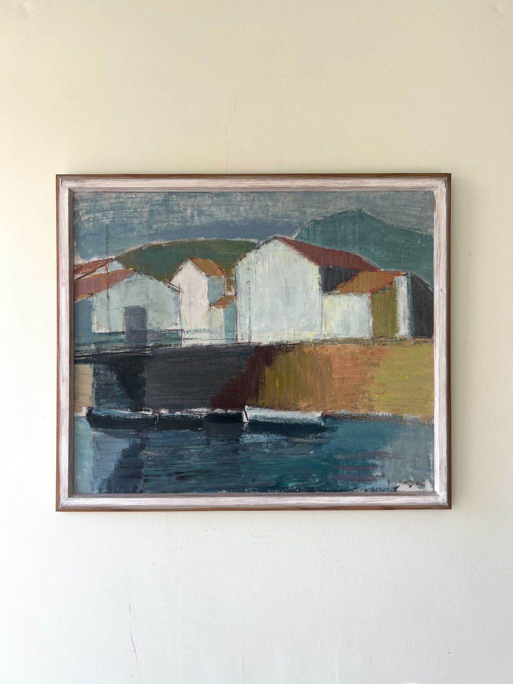 Framed vintage oil painting of a coastal scene with buildings and water. Available at Hue. 