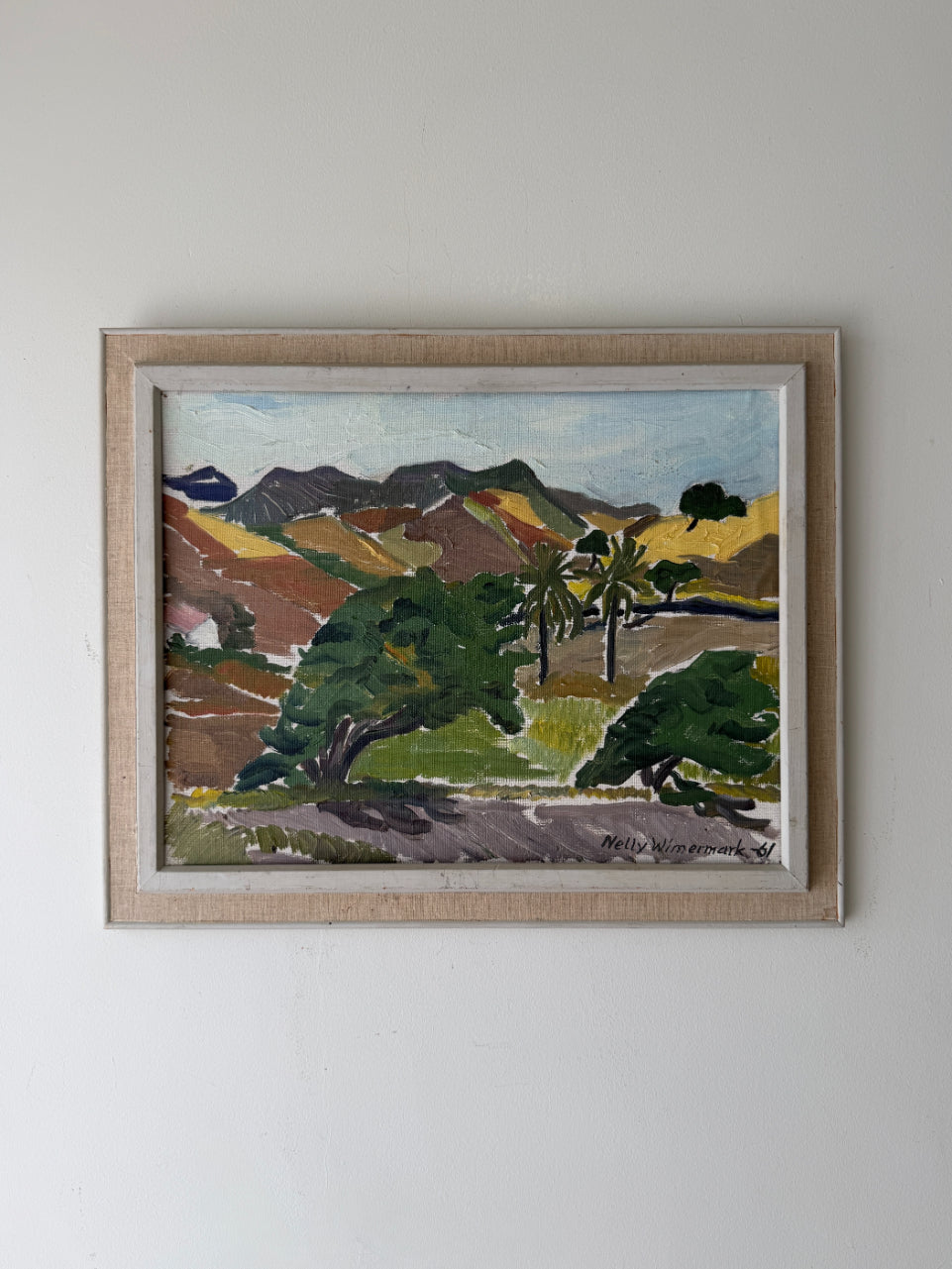 Framed vintage oil landscape painting with mountains and palm trees. Available at Hue. 