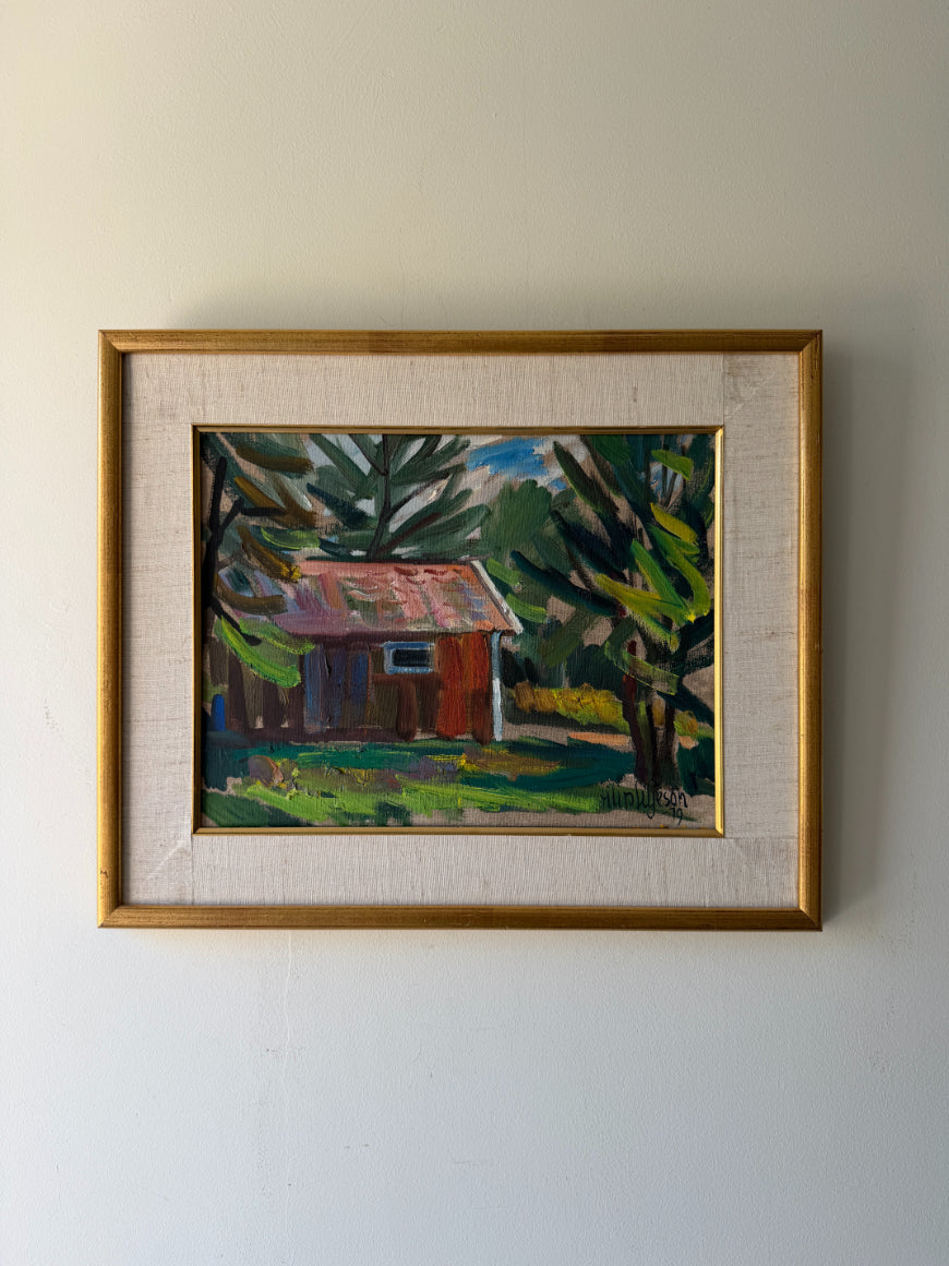 Framed vintage oil painting of a cabin in the woods. Available at Hue. 