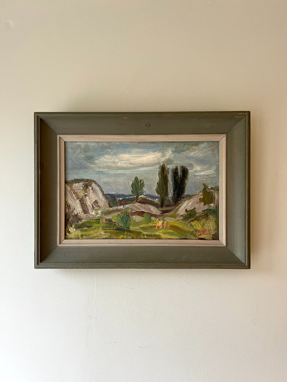 A framed vintage oil painging of a rocky rural landscape. Available at Hue. 
