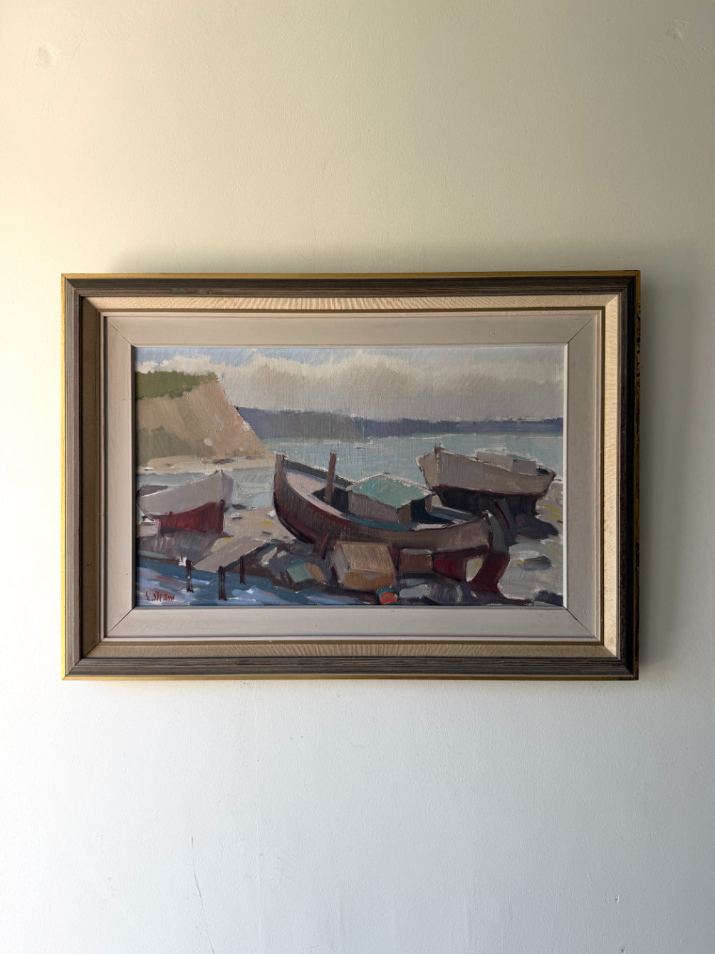 Framed vintage oil painting of boats on a dock. Available at Hue. 