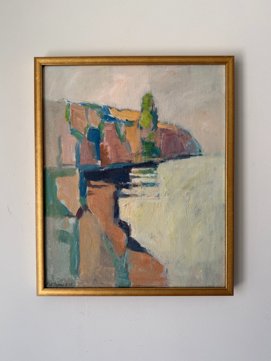 A semi-abstract vintage landscape oil painting. The painting features earthy tones of brown, beige, green, and blue, with a prominent gold frame. Available at Hue.