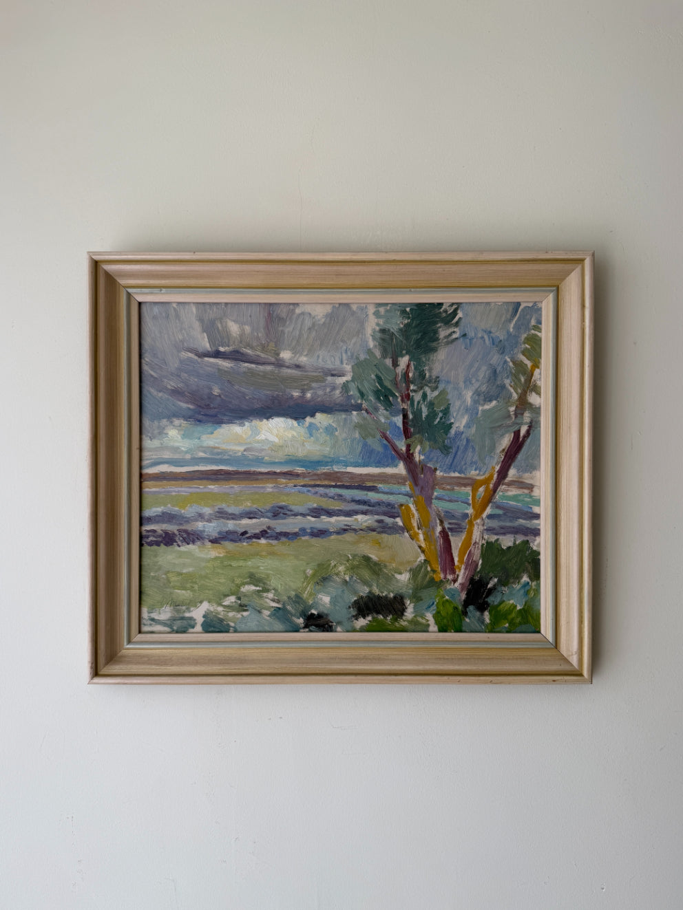 Framed vintage oil painting of a landscape with trees and water. Available at Hue.