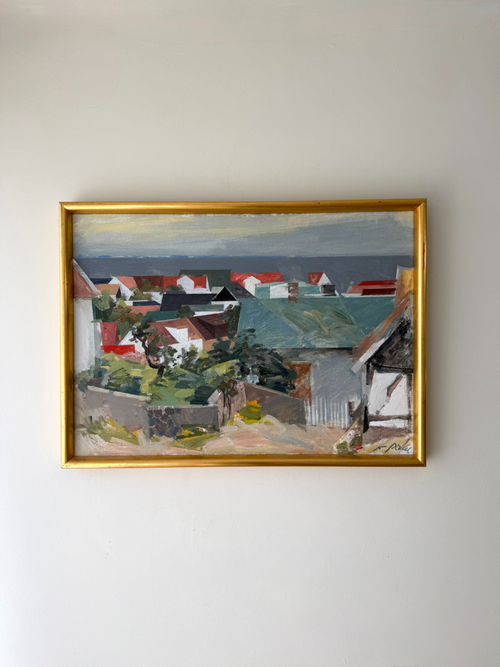 Framed vintage oil painting of a coastal village scene. Available at Hue.