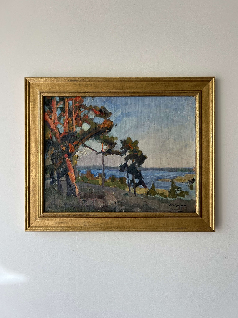 Framed, vintage oil painting of a landscape with trees and a body of water, available at Hue.