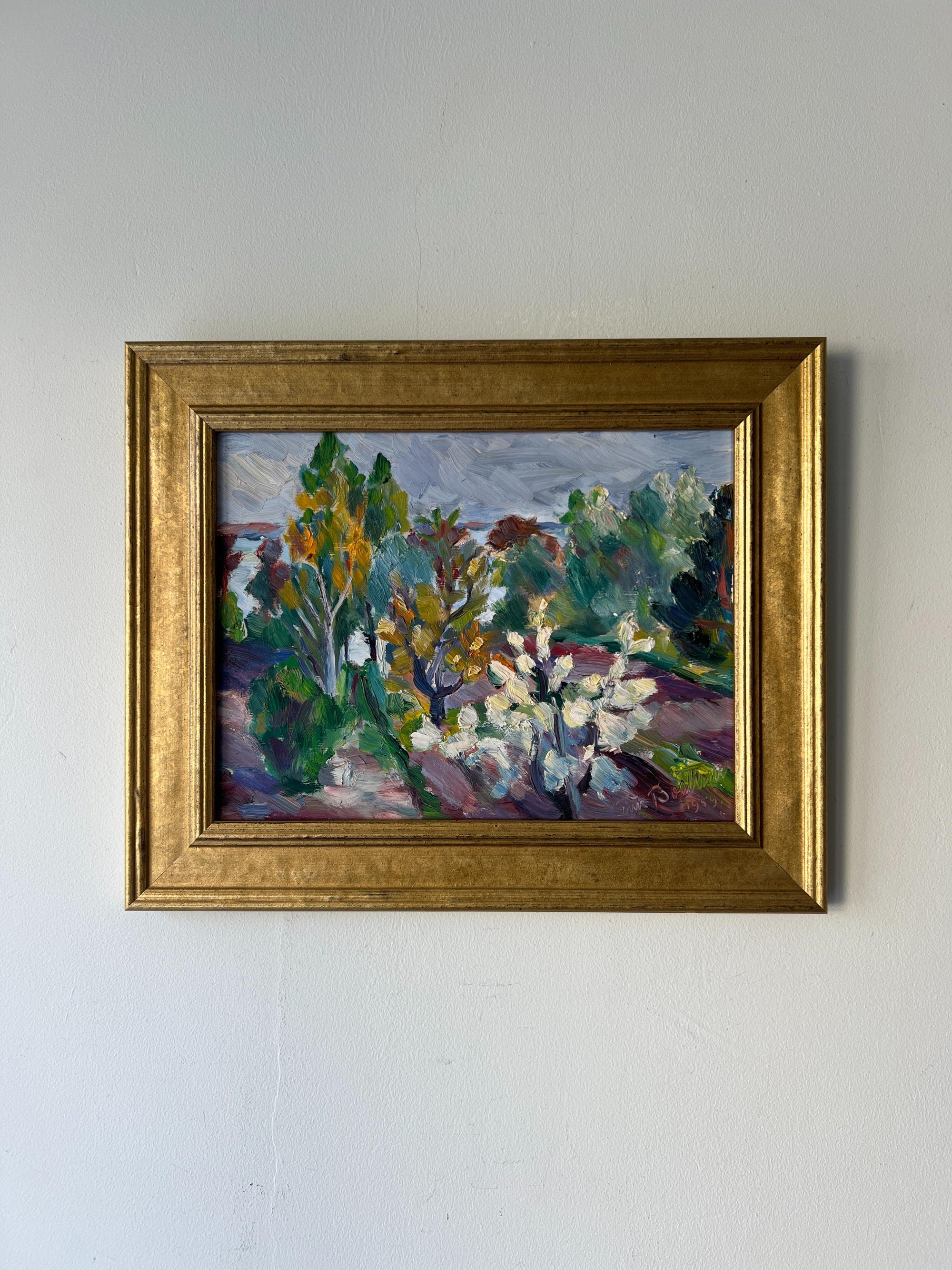 Framed vintage oil painting of a landscape with trees, shrubs and blossom flowers. Available at Hue.