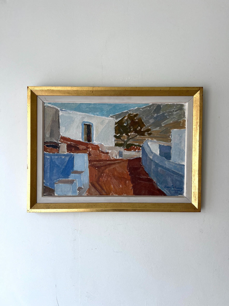 Framed vintage oil painting of a Mediterranean scene with white buildings and blue sky. Available at Hue.
