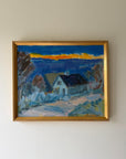 A framed vintage landscape oil painting of a house in a village under a blue sky with a yellow sunset. Available at Hue. 