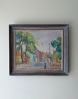 Framed vintage oil painting of a street scene with trees and buildings and a boy on a bicyle. Available at Hue. 