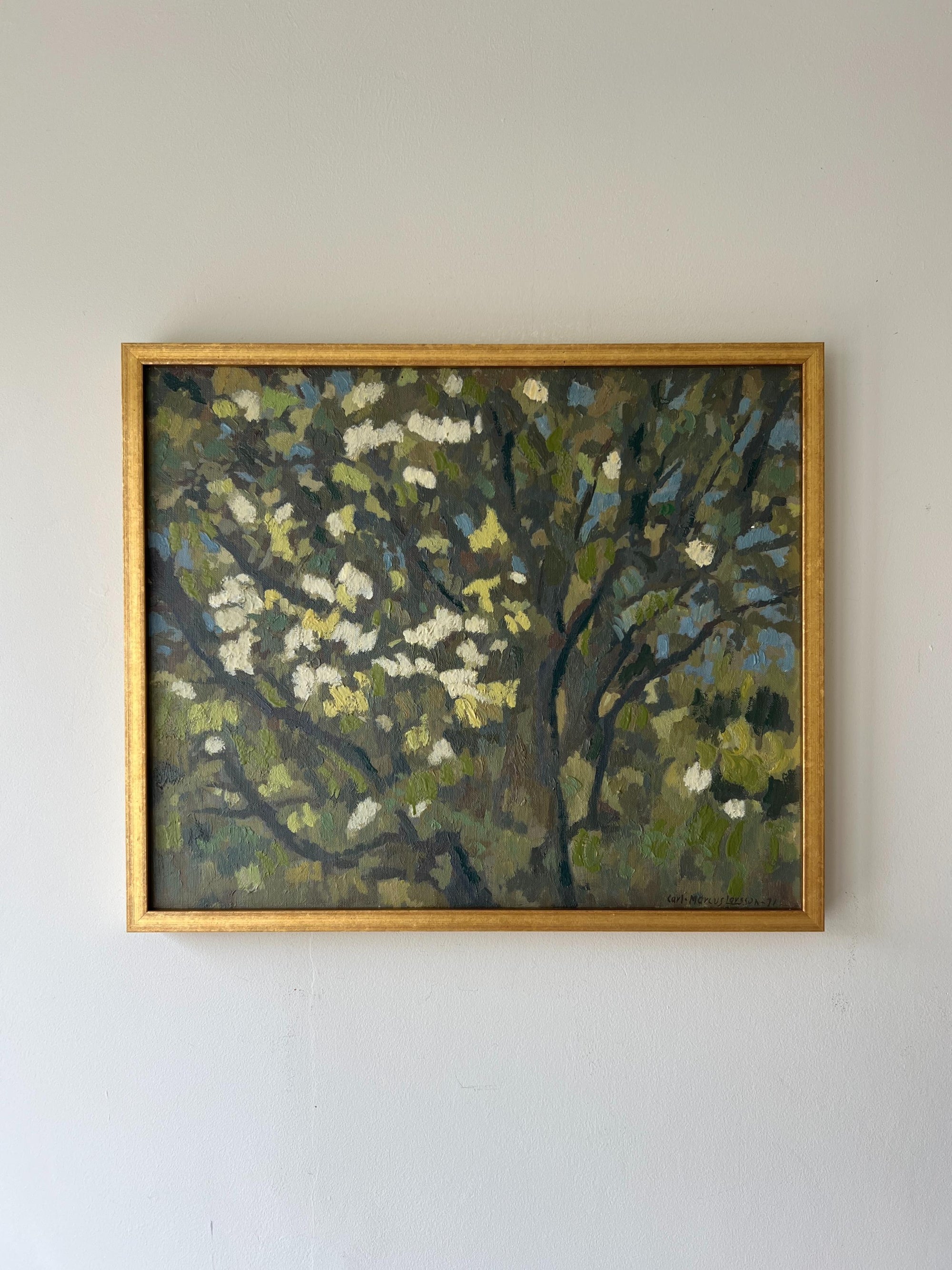 A framed vintage oil painting of blossom tree branches. Available at Hue. 