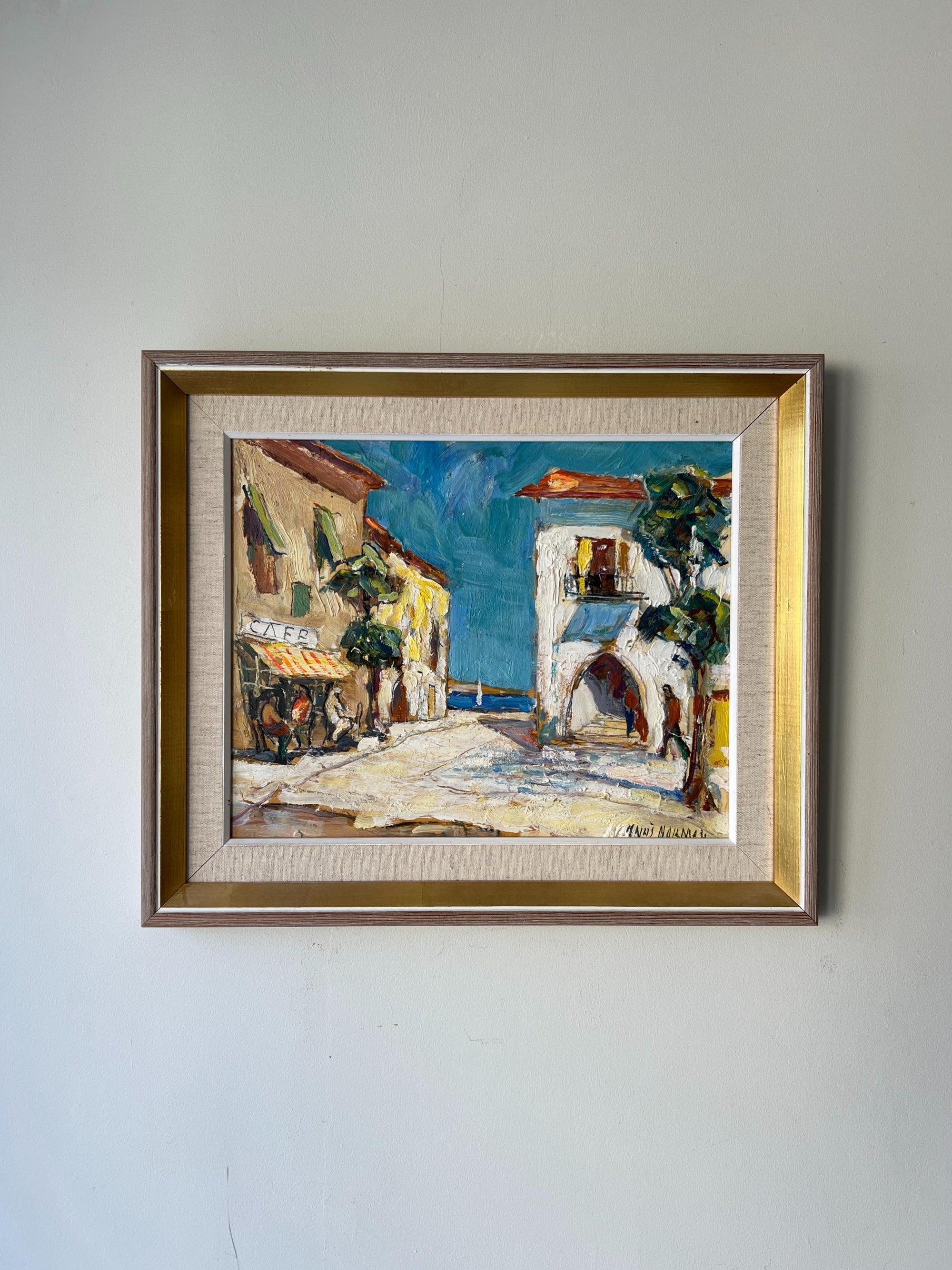 Framed vintage oil painting of a French coastal village scene. Available at Hue.