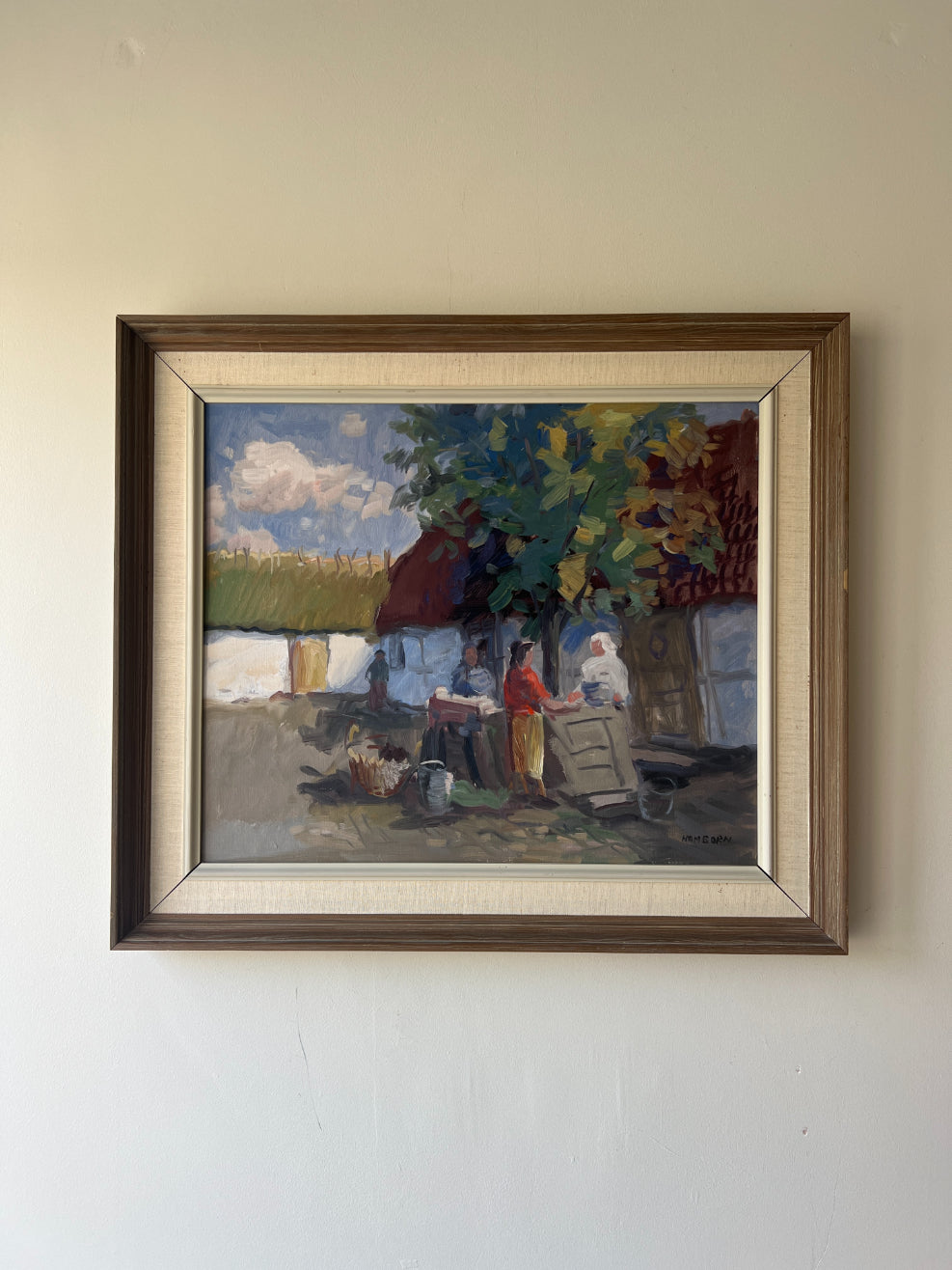 Framed vintage oil painting of a village scene with figures. Available at Hue. 