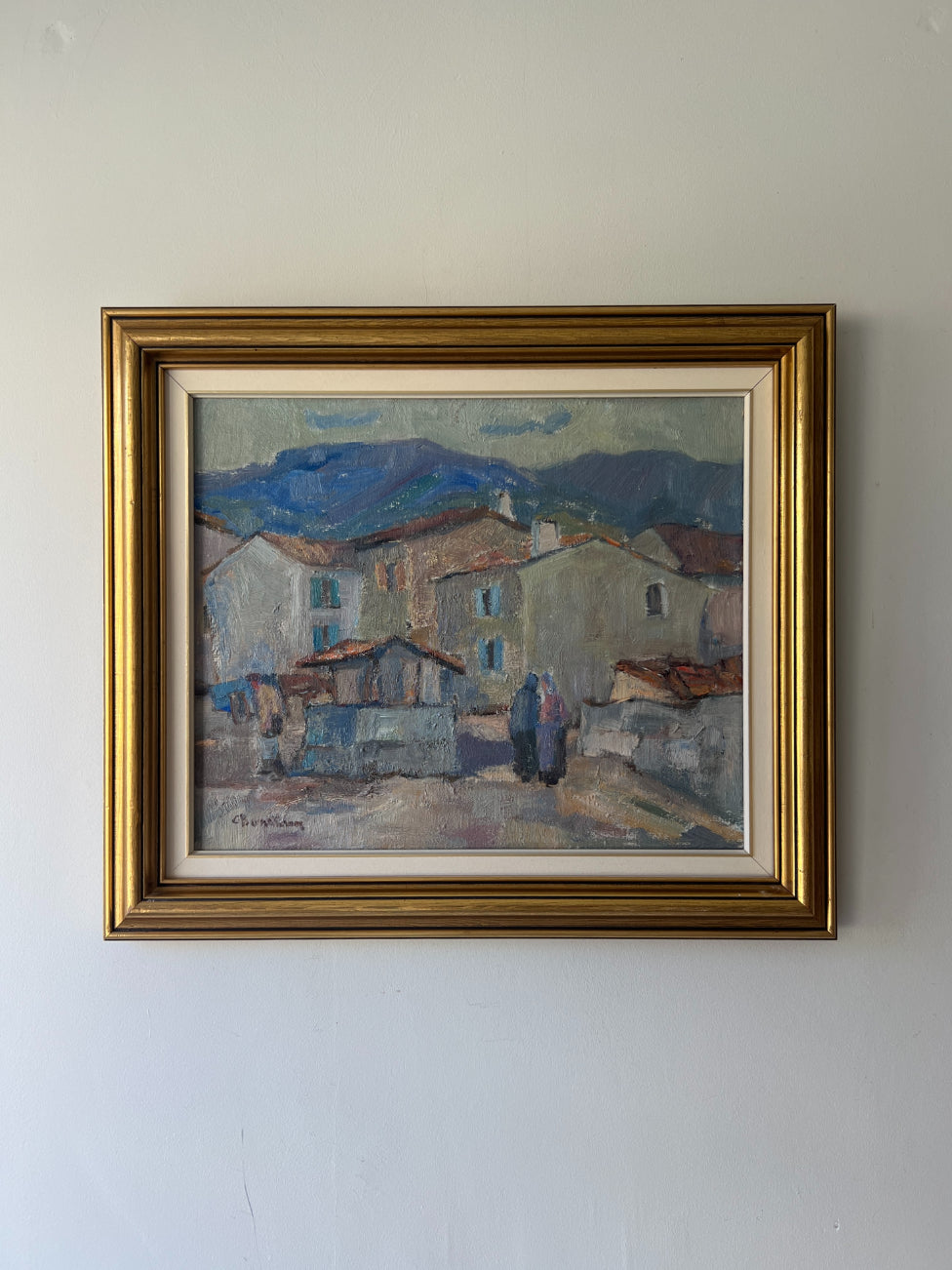 Framed vintage oil painting of a village scene with mountains. Available at Hue.