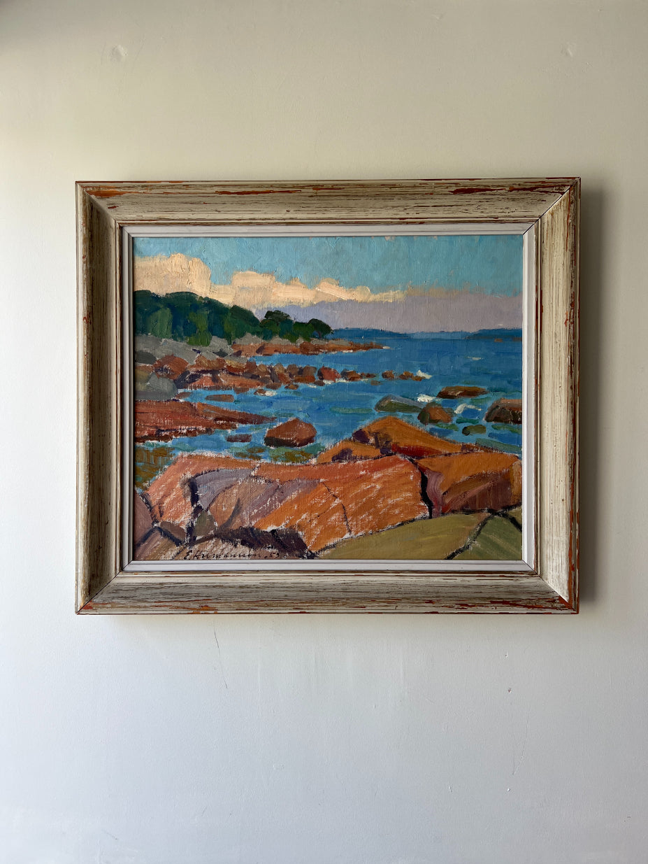 Framed vingtage oil painting of a coastal scene with rocks and water. Available at Hue. 