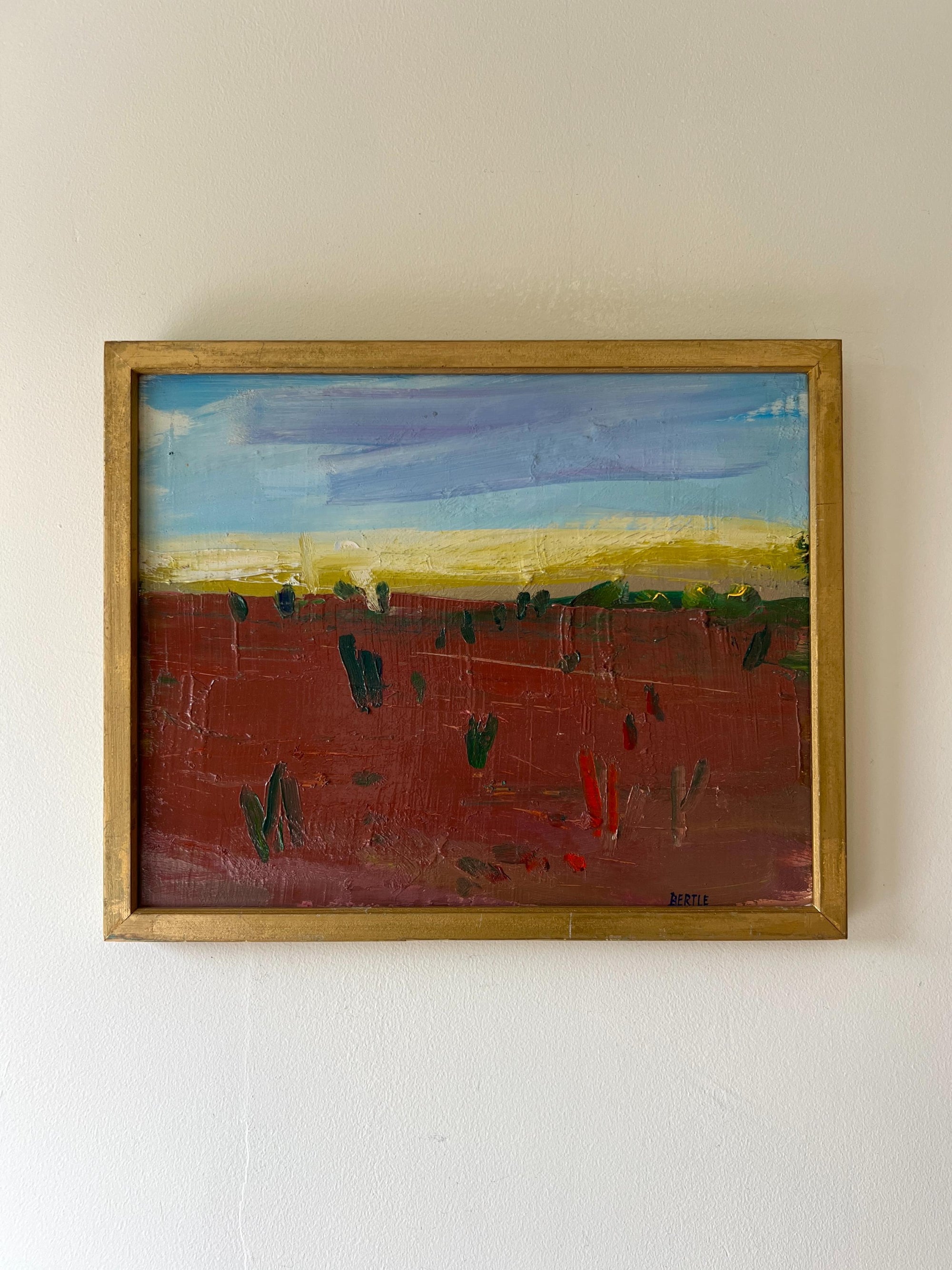 Framed vintage oil painting of a landscape with a red foreground and blue sky, available at Hue