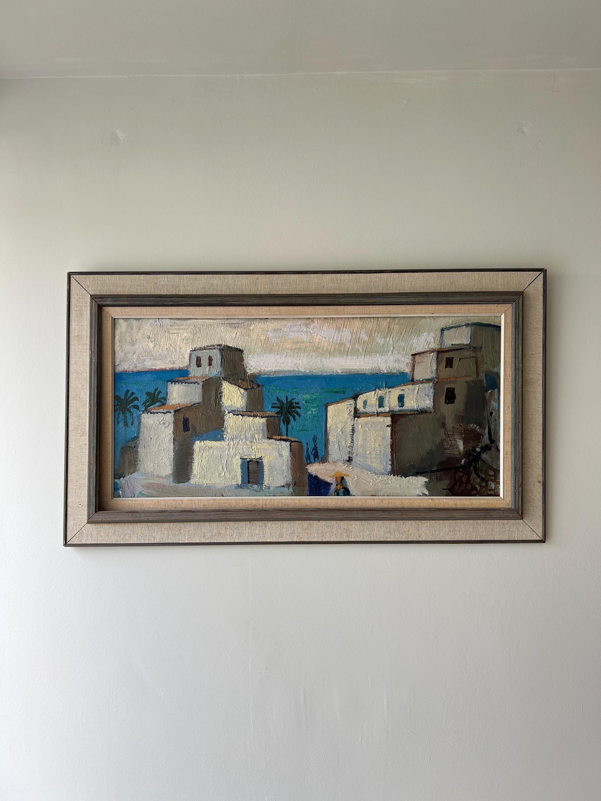 Framed vintage oil painting of a coastal scene with whitewashed buildings and the distant sea, available at Hue.
