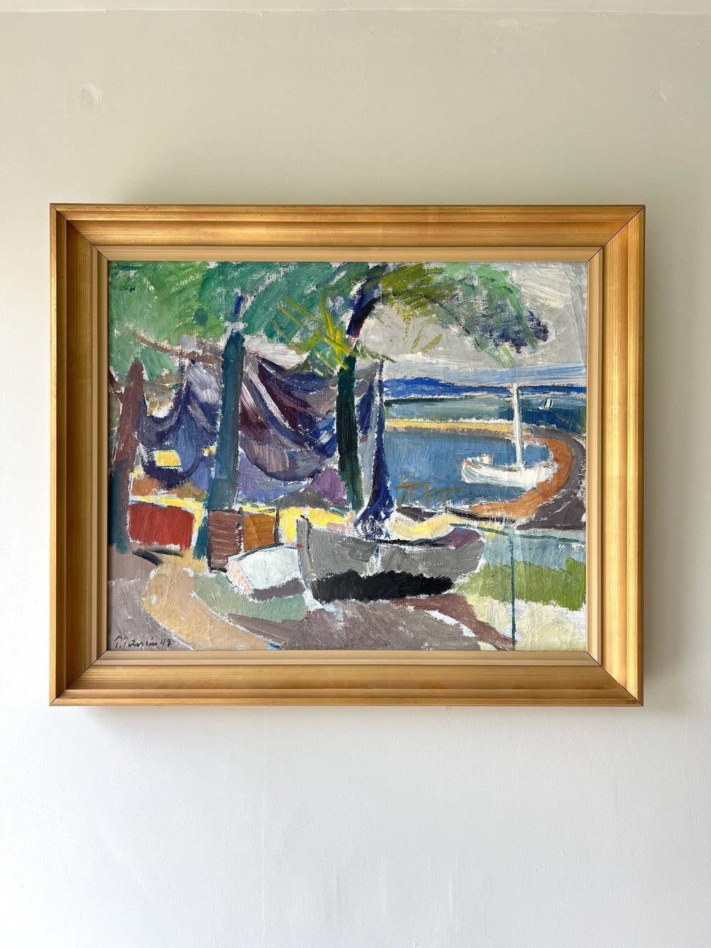Framed vintage oil painting of a coastal scene with boats and trees in a vintage gilt frame, available at Hue.