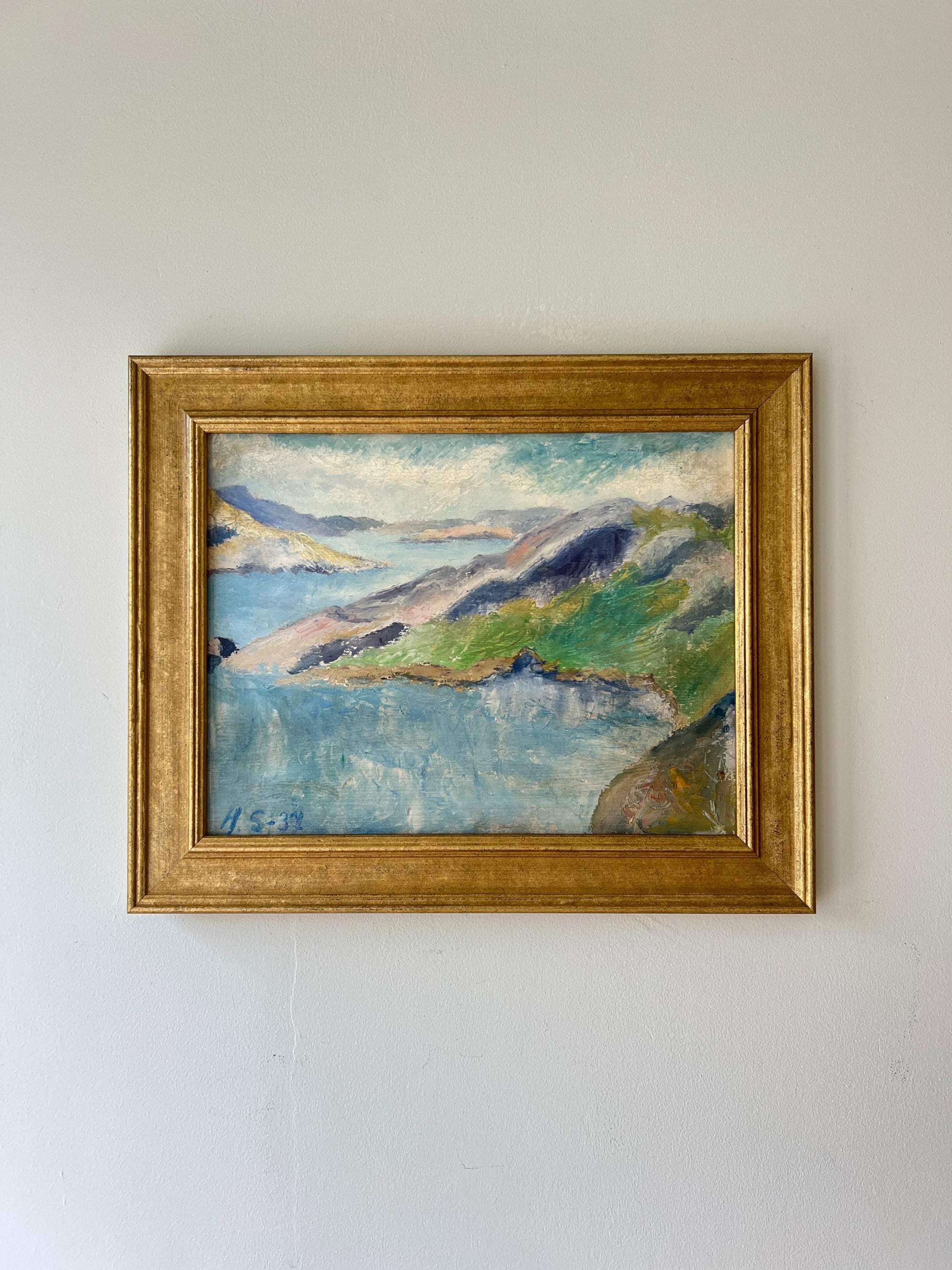 Framed vintage oil painting of a seascape with hills in a gilt frame, available at Hue. 