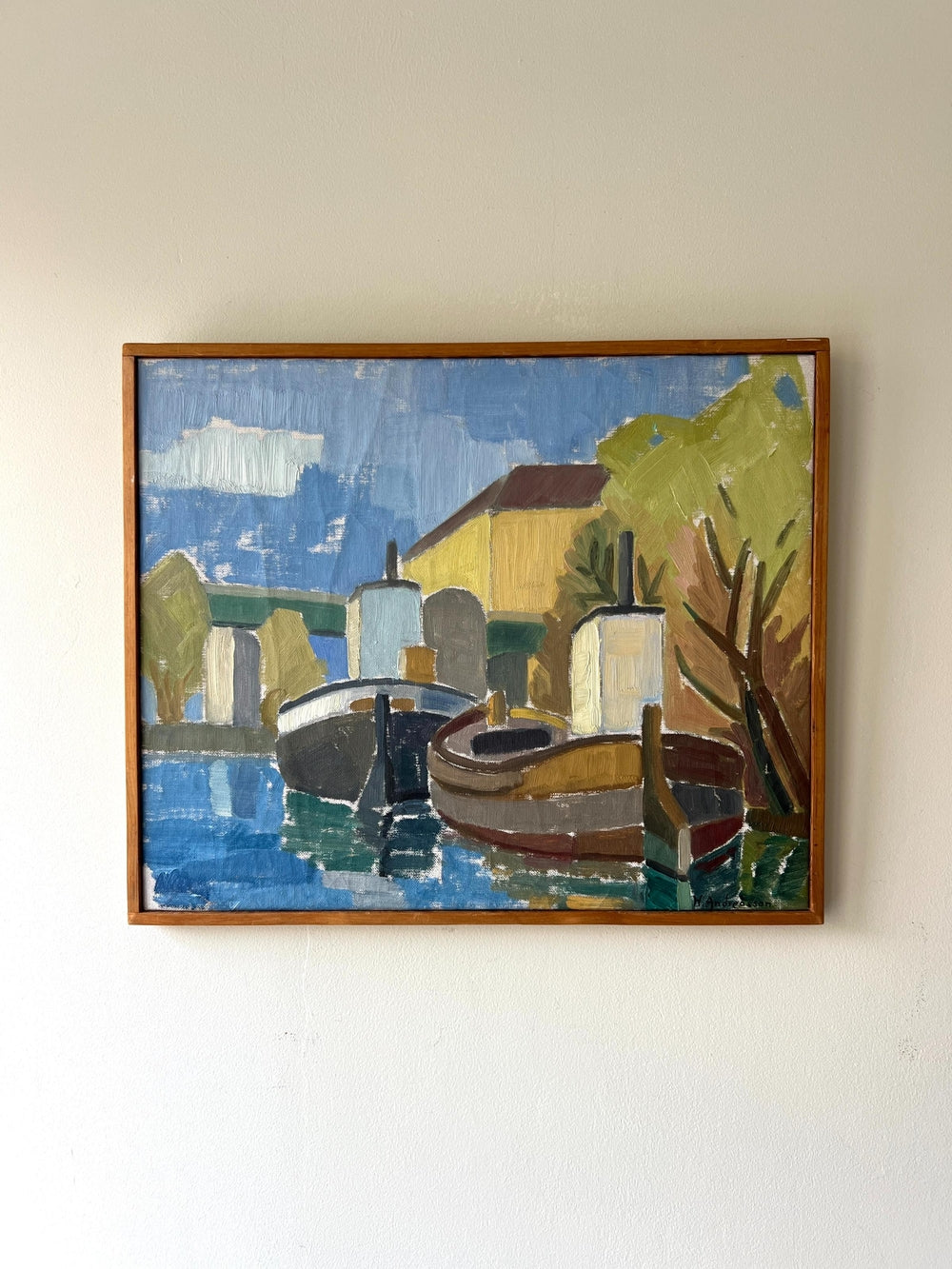 Framed vintage oil painting of a coastal scene with boats and buildings in a slim wooden frame, available at Hue.