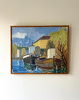 Framed vintage oil painting of a coastal scene with boats and buildings in a slim wooden frame, available at Hue.