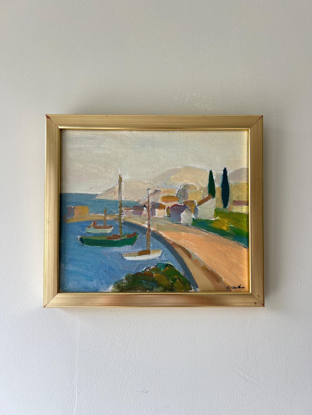 Framed vintage oil painting of a coastal scene with boats and a dock, available at Hue.