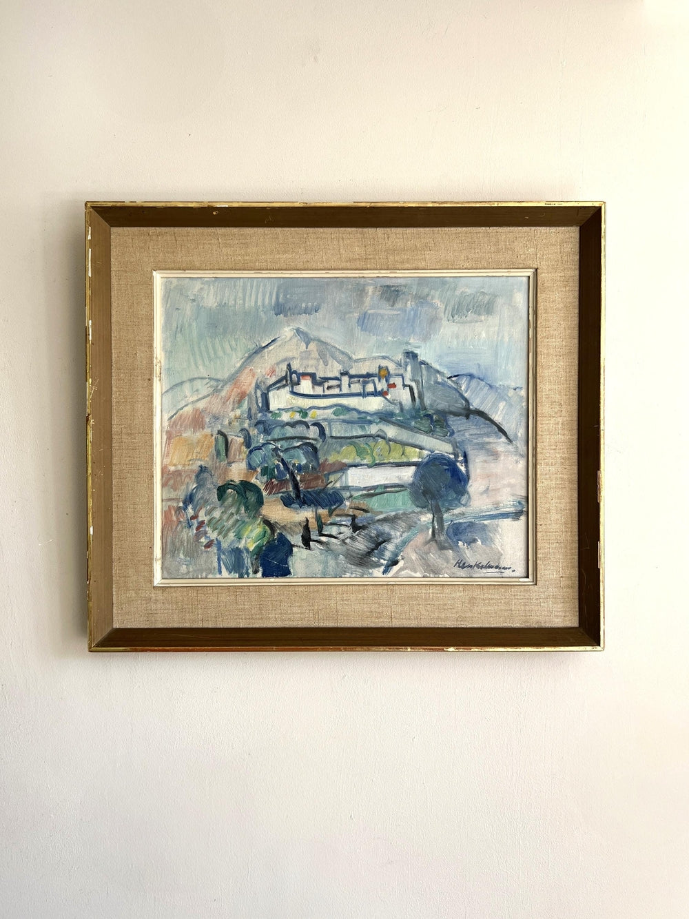 Framed vintage oil painting of a landscape with a hilltop village in the distance, available at Hue.